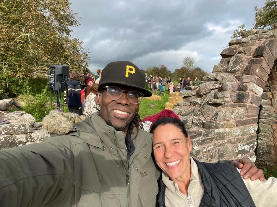 Kwame Afrik and Melanie Pontet-Piccolomini at an outdoor community gathering