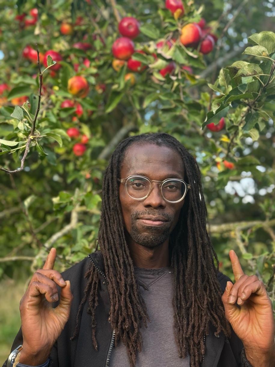 Kwame Afrik, founder and sign language teacher, signing outdoors