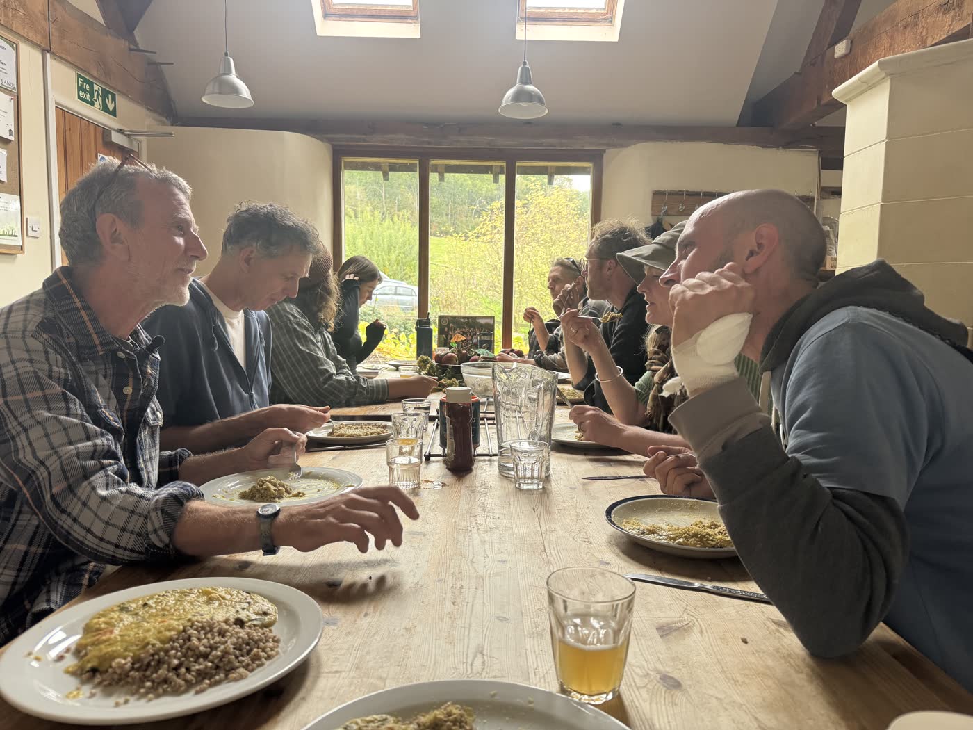 A long table of people sharing a communal meal