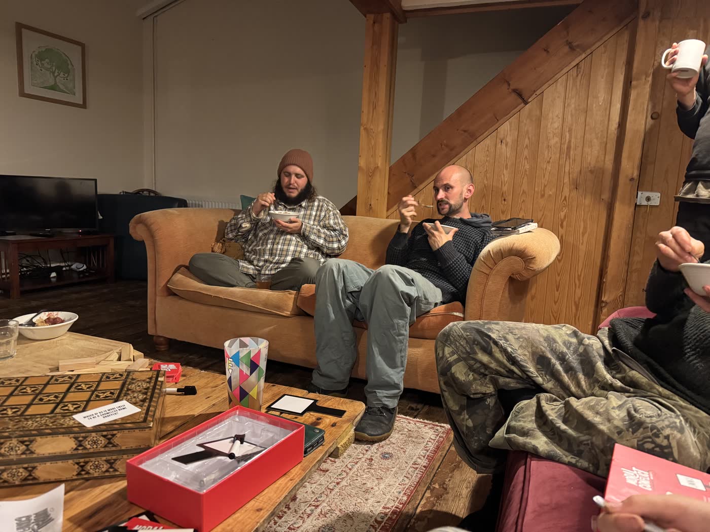 People relaxing and signing together in a living room