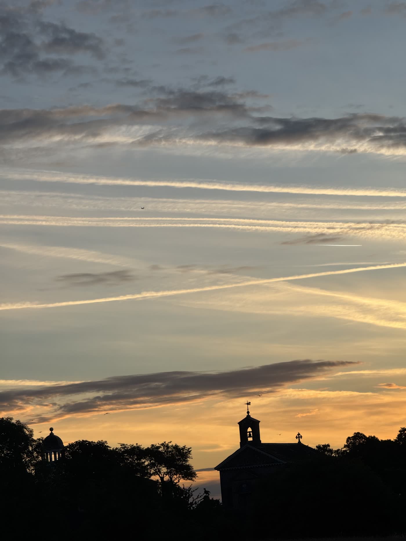 Sunset silhouette over a village church